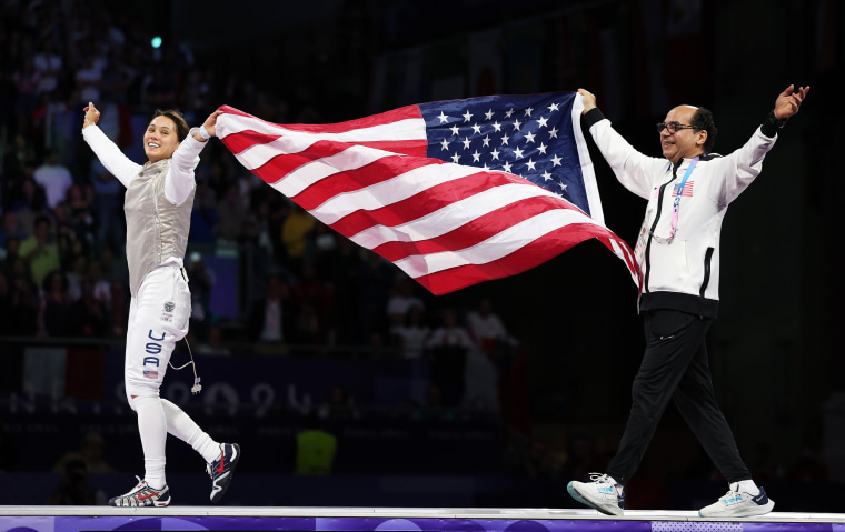 Lee Kiefer of the United States celebrates with her coach Amgad Khazbak winning the gold medal in the women's individual foil on July 28, 2024 in Paris