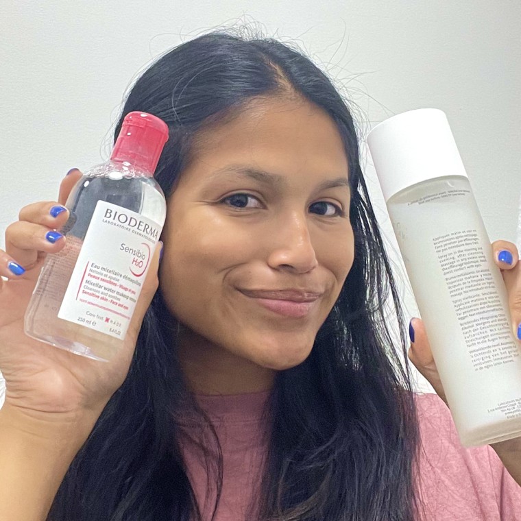 Woman holds Yon-Ka Paris Toning Lotion and Bioderma Sensibio H2O Micellar Water in her hands.