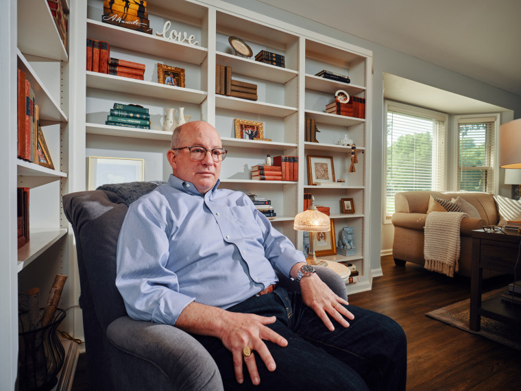 Ted Fitzpatrick sits on a couch