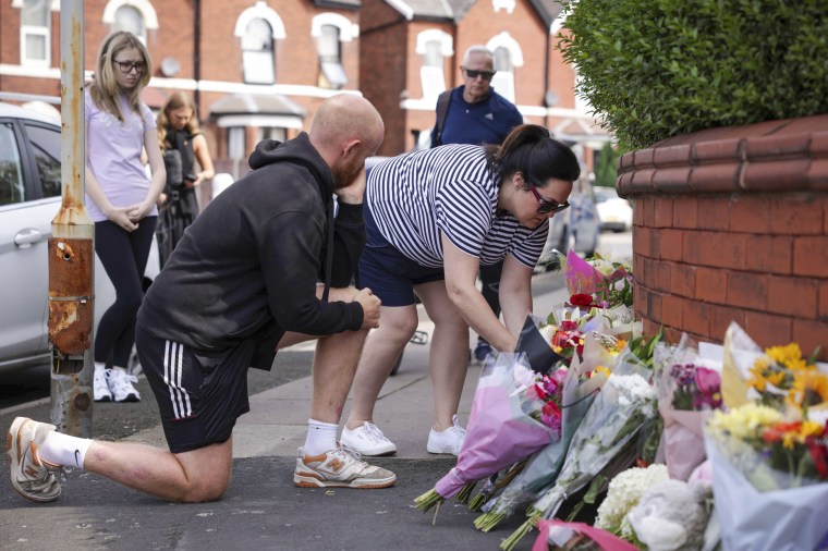 People leave flowers near the scene.