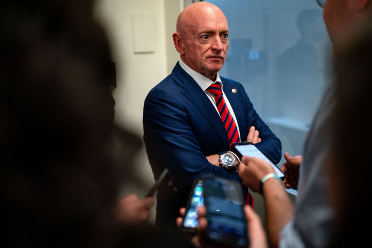 Mark Kelly speaks to reporters as he waits to take the Senate subway from the US Capitol to the Hart Senate Office Building