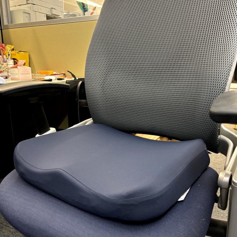 The dark navy blue Tempur-Pedic Seat Cushion in an office chair.