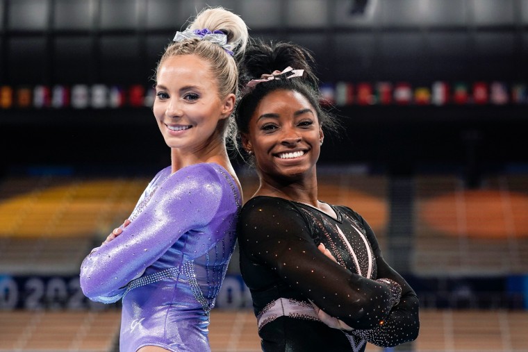 MyKayla Skinner, left, and Simone Biles pose back to back and smile