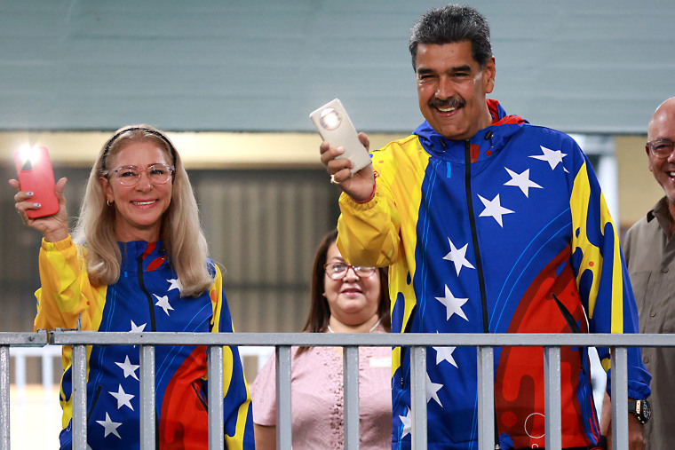 Incumbent President of Venezuela Nicolás Maduro smiles next to the first lady Cilia Flores after casting his vote during the presidential elections at Escuela Ecológica Bolivariana Simón Rodríguez on Sunday in Fuerte Tiuna, Caracas, Venezuela.