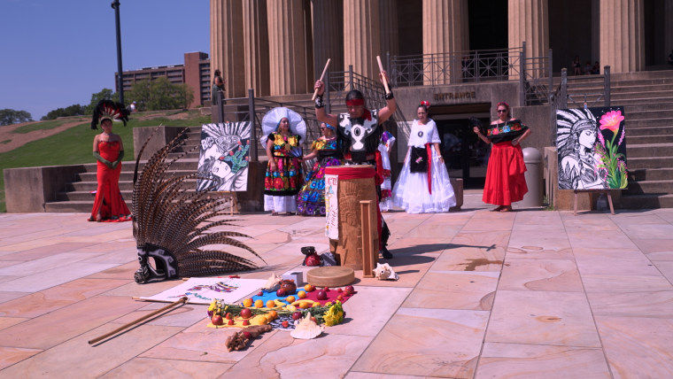 Members of the Nashville community perform a traditional blessing for the collection of artifacts outside the Parthenon.