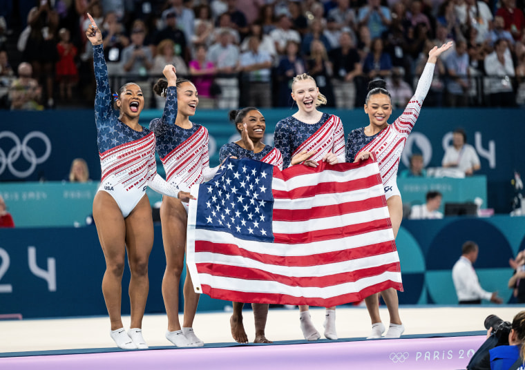 Jordan Chiles, Hezly Rivera, Simone Biles, Jade Carey, Sunisa Lee of USA celebrate victory while the women´s team final with the USA flag  on day four of the Olympic Games Paris 2024 at Bercy Arena on July 30, 2024 in Paris, France.