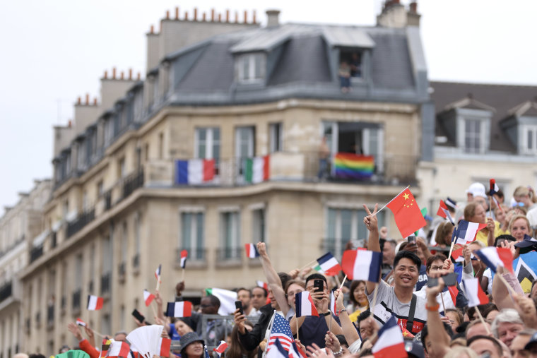 Spectators wave flags during the opening ceremony.