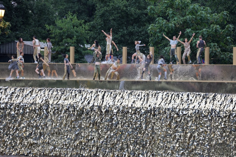 Dancers perform on the banks of the Seine.