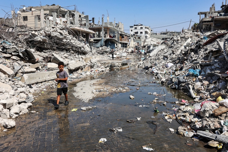 A boy walks among rubble in the Jabalia camp in the northern Gaza Strip on August 14, 2024. 