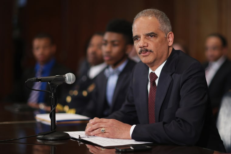 Eric Holder menyampaikan sambutan di Departemen Kehakiman