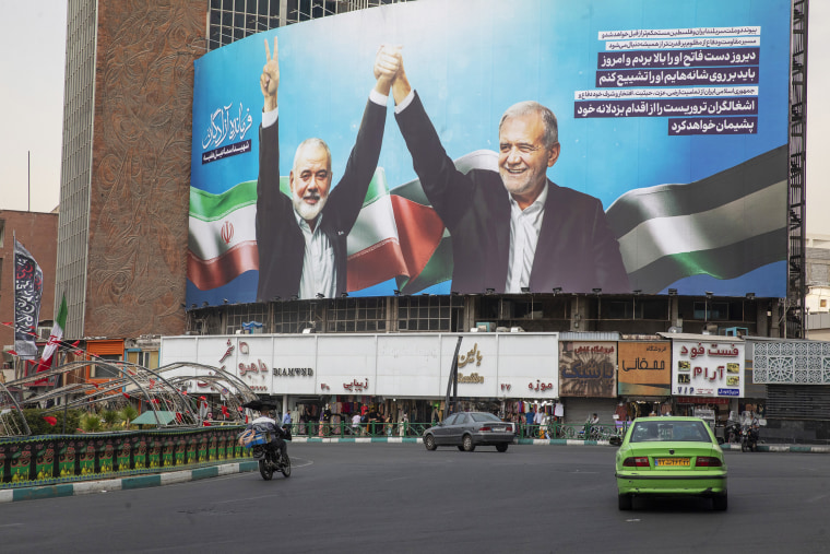 The large picture of Ismail Haniyeh and Masoud Pezeshkian, the new and reformist president of Iran, which was taken at the inauguration ceremony, has been installed in Valiasr Square in Tehran. Haniyeh, who had lived in Qatar, was killed in an airstrike in Tehran after attending the inauguration of Iran's new president. His body is due to return to Qatar for an official funeral and burial tomorrow. 