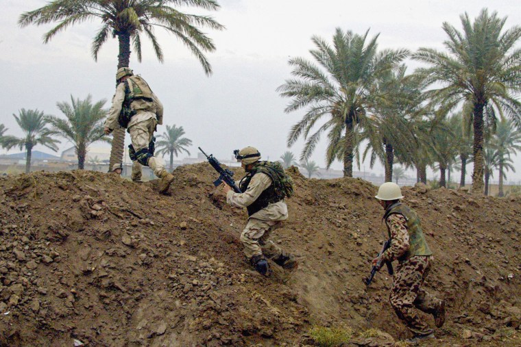 US soldiers from the 82nd Airborne division cross a hill.