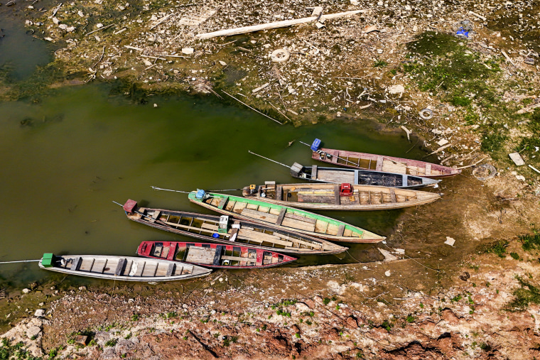 Boats sit on the bank of the Acre River.