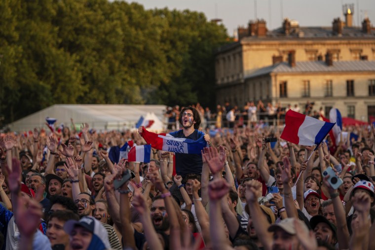 Spectators celebrate as France's Leon Marchand wins gold in the men's 200m individual medley final from the fan zone set up at Club France at the 2024 Summer Olympics on August 2, 2024. in Paris, France. 