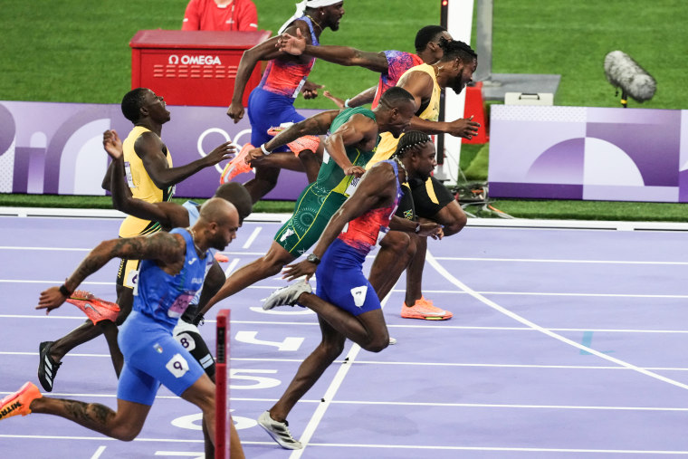 Runners cross the finish line on the track