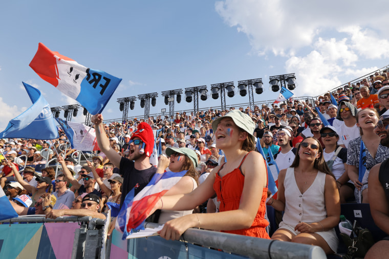 Frances's fans cheer for their team at a beach volleyball match at the Paris Olympics on July 30, 2024. 