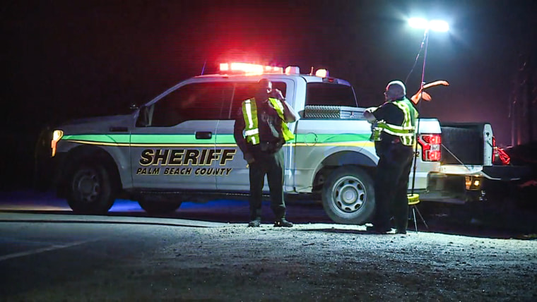 A Palm Beach County Sheriff's truck is seen on the scene of a crash at night