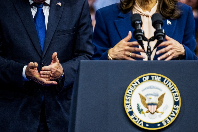 Vice President Kamala Harris speaks as Minnesota Governor Tim Walz gestures