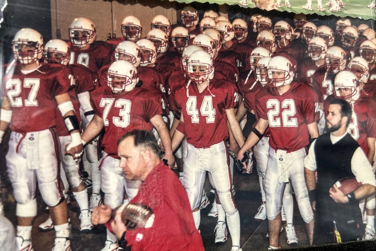 Tim Walz, center, with the Mankato West varsity football team.