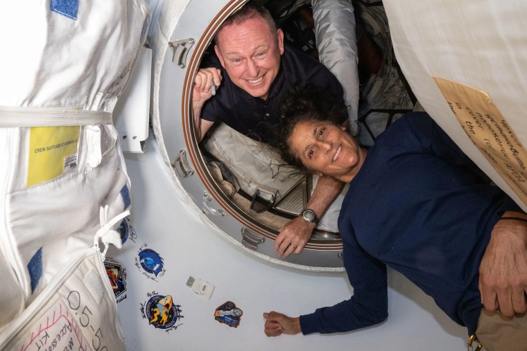 NASA’s Boeing Crew Flight Test astronauts Butch Wilmore and Suni Williams inside the vestibule between the forward port on the International Space Station’s Harmony module and the Starliner spacecraft.