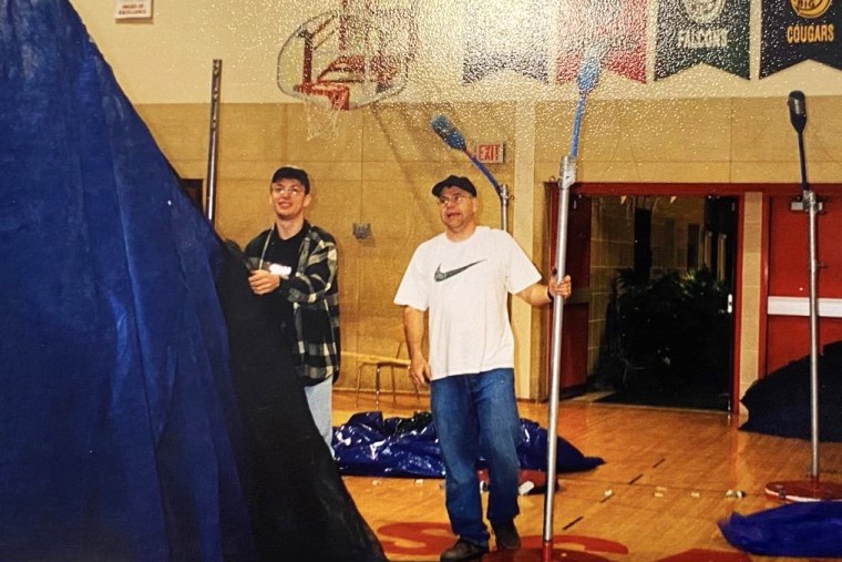 Tim Walz, right, setting up for prom with a student in 2002.