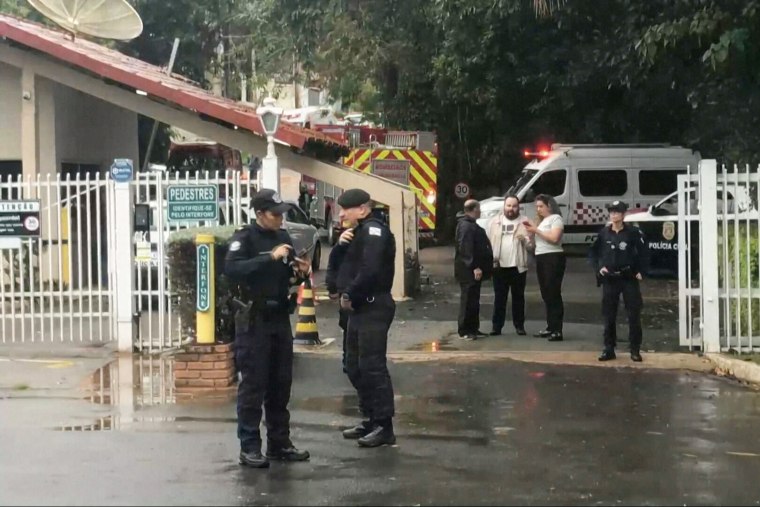 Responders near the site of the crash in a residential area of Vinhedo, Brazil on Friday.