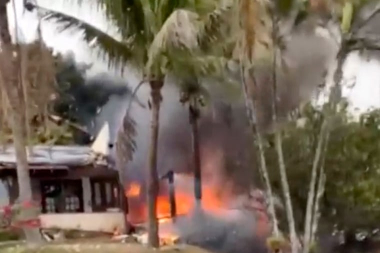 Fire and smoke from a plane that crashed by a home 