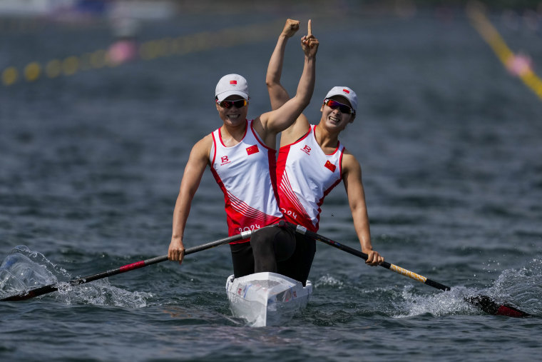 Chinese Sun Mengya and Xu Shixiao react to winning gold in the women's canoeing double 500 meter final 