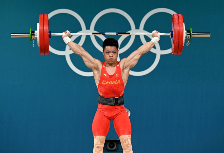 Chinese Li Fabin competes in men's 61 kg weightlifting event