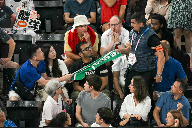 Politics tamfitronics A security member removes a banner showing the name 