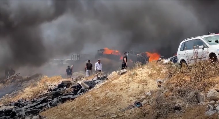 Fires burn in the West Bank village of Burqa after settler attacks on June 7, 2024.