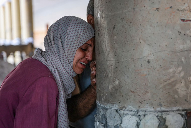 A person cries inside a school used as a temporary shelter.