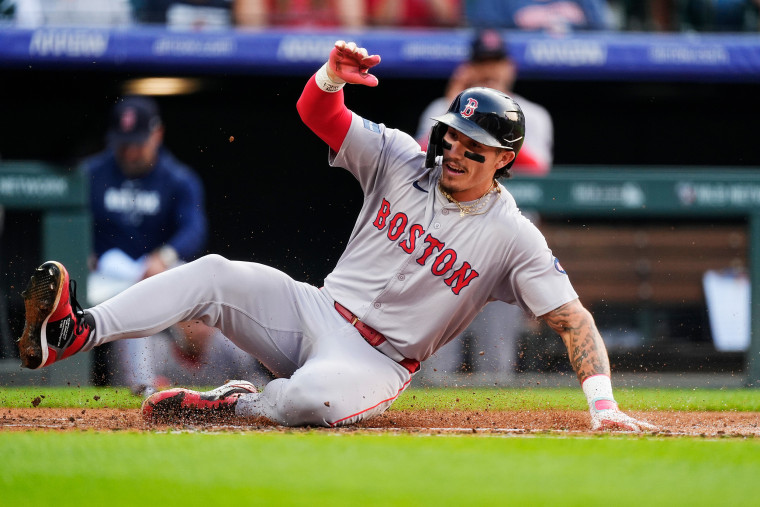 Boston Red Sox's Jarren Duran slides safely across home plate