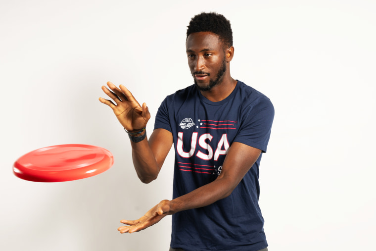 Marques Brownlee about to grab a red frisbee.