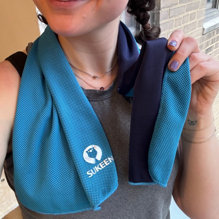 Woman wearing the Sukeen cooling towel over her shoulders