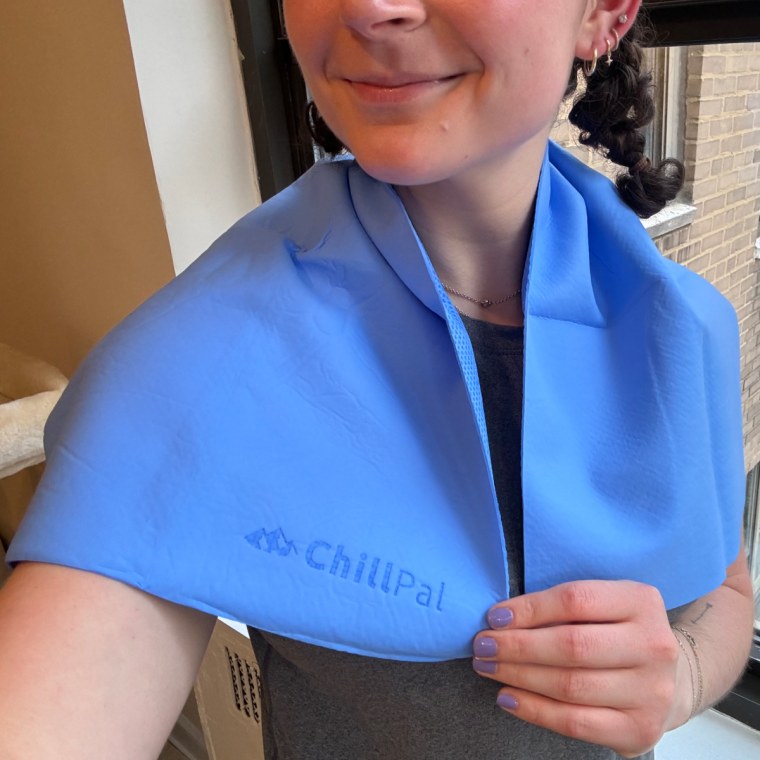 Woman wearing a Chillpal cooling towel over her shoulders