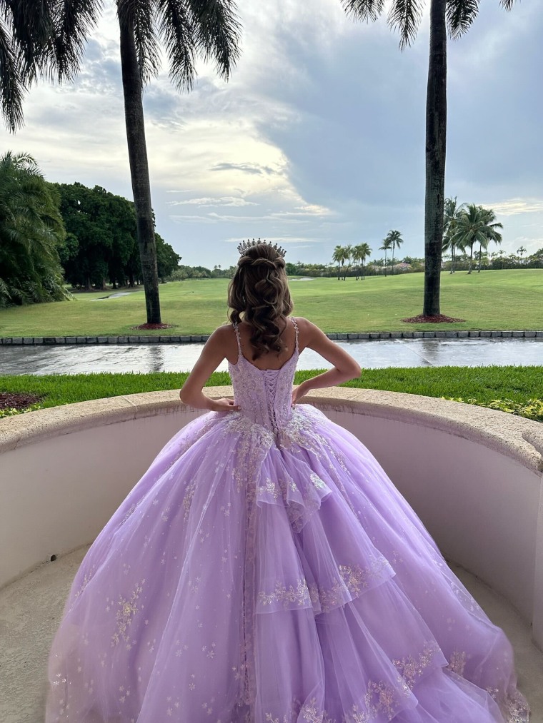 A teen poses for pictures before her quinceañera party in Miami.