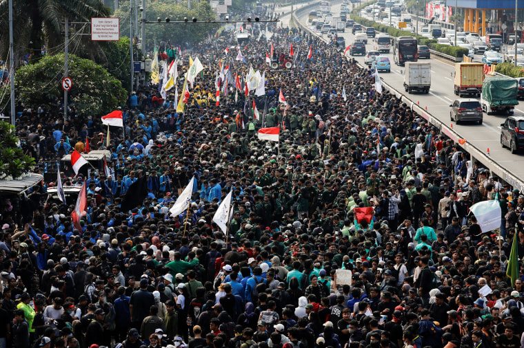 Protest against planned controversial revisions to election law outside the Parliament building in Jakarta