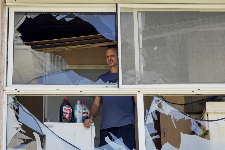 A man looks out from a damaged home in Acre, north Israel following a strike on Aug. 25, 2024.