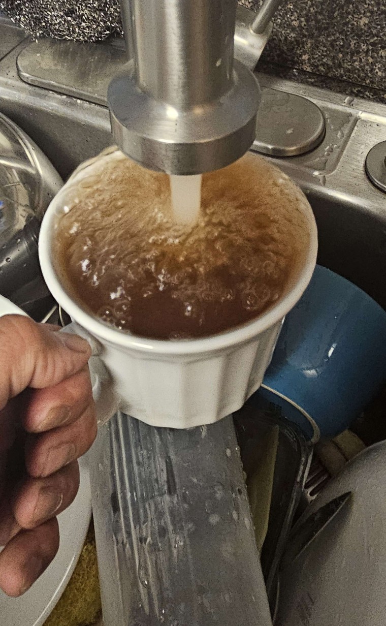 A photo submitted to Hots&Cots shows brown water flowing from a faucet. The person who submitted the photo said it was shot at Joint Base McGuire-Dix-Lakehurst, N.J.