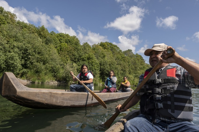 Yurok tribal members lead a redwood canoe tour on the lower Klamath River in Klamath, Calif., on June 8, 2021. As the salmon of the Klamath have dwindled, the Yurok tribe has turned to alternative revenue like eco-tourism and canoe tours to support its people.