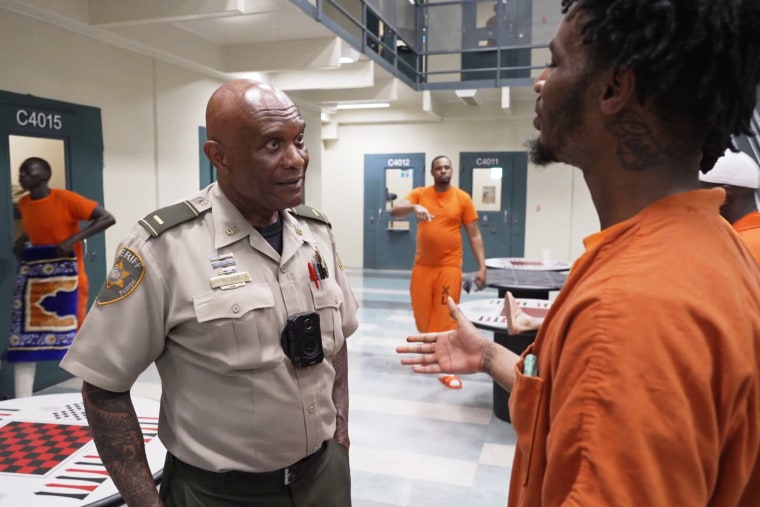 Lieutenant Michael Lewis speaks with inmates.