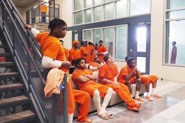 Members of the Orleans Parish jail’s new model pod watch a television show together.
