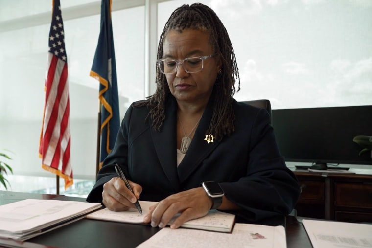 New Orleans Sheriff Susan Hutson writes in a notebook