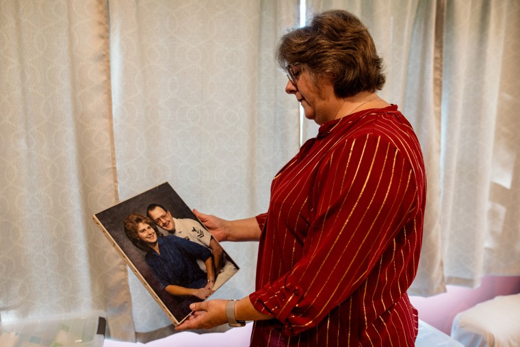 Ann Faucette holds a portrait of her and her husband.