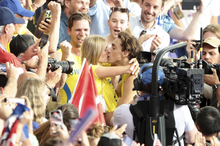 Gold medalist Armand Duplantis aka Mondo Duplantis of Sweden celebrates with his girlfriend Desiré Inglander after setting a new world record during the Men's Pole Vault Final on day ten of the Olympic Games Paris 2024 at Stade de France  on August 05, 2024 in Paris, France. 