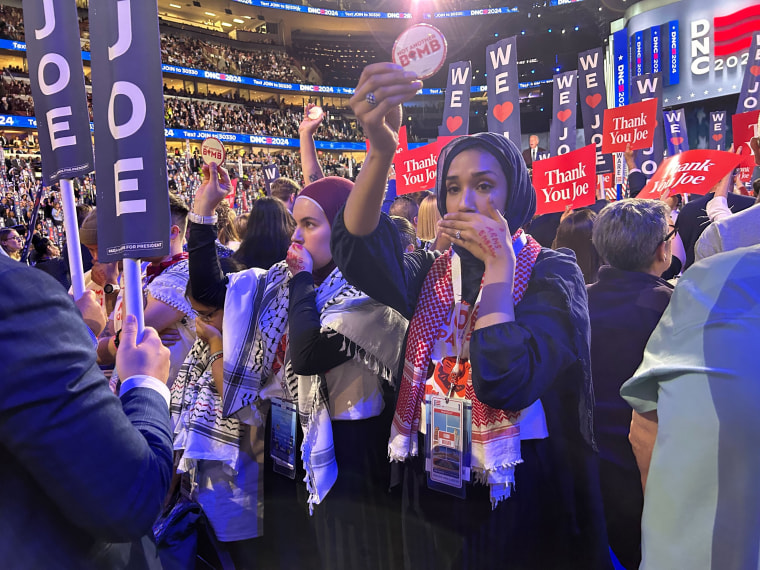 Pro-Palestinian protesters turn their backs as President Joe Biden speaks.