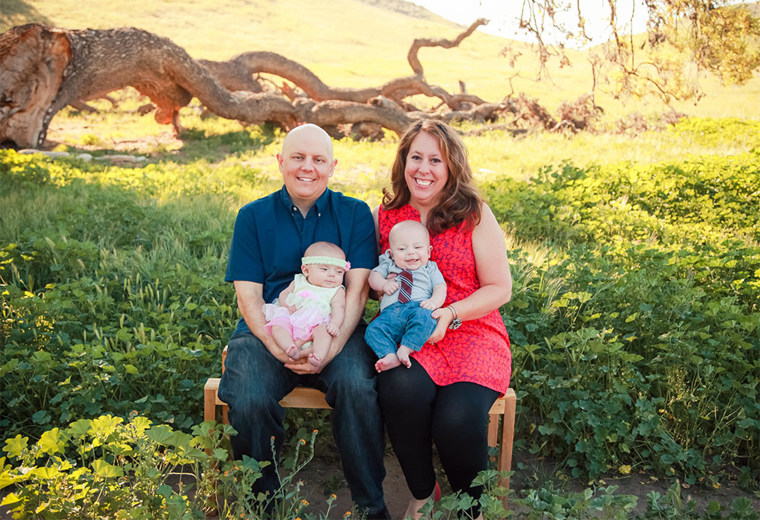 My husband and me with our newborn twins, who are now 8 years old.