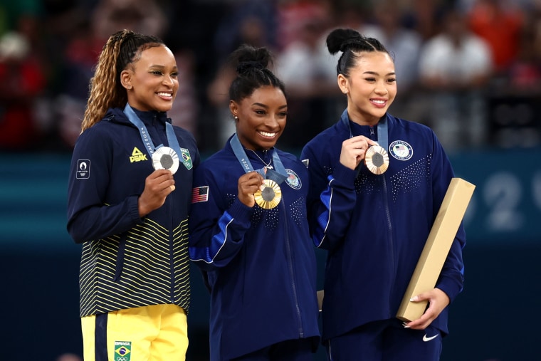 Rebeca Andrade , Simone Biles and Sunisa Lee pose on the podium during the Artistic Gymnastics Women's All-Around medal ceremony on day six of the Olympic Games Paris 2024 at Bercy Arena on August 01, 2024 in Paris, France. 