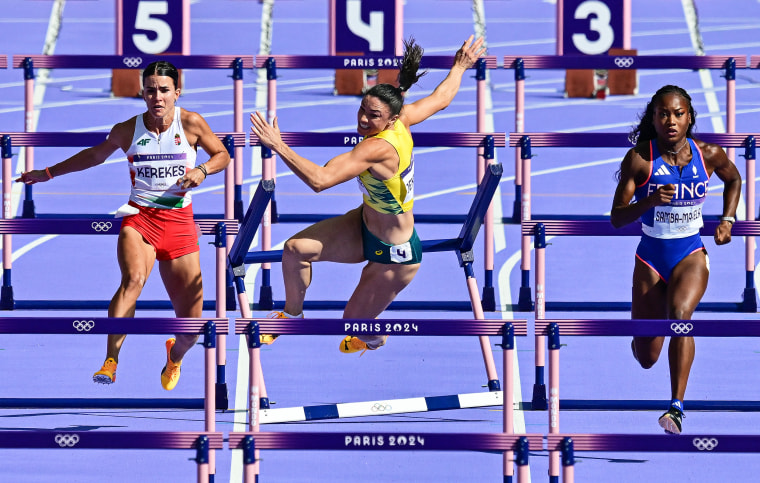 Michelle Jenneke falls as Hungary's Greta Kerekes (L) and France's Cyrena Samba-Mayela (R) compete in the women's 100m hurdles.